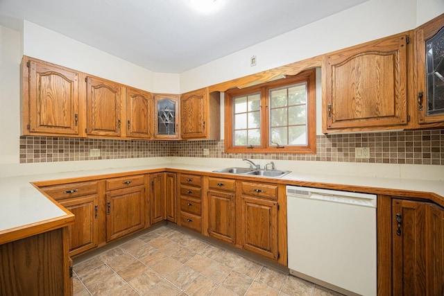 125 S Hamilton Rd, Columbus, OH 43230 - kitchen featuring white dishwasher, a sink, brown cabinets, and tasteful backsplash