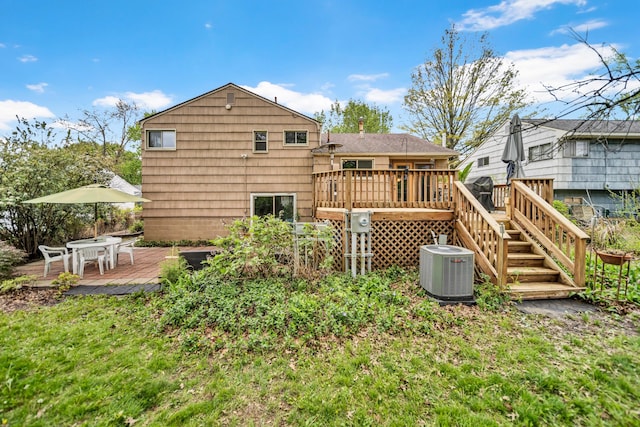 back of property featuring central AC unit and a wooden deck