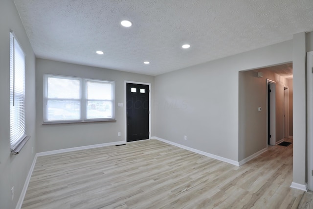 1235 Beechwood Rd, Columbus, OH 43227 - entryway with light wood-type flooring, recessed lighting, and a textured ceiling