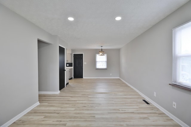 1235 Beechwood Rd, Columbus, OH 43227 - unfurnished room featuring a textured ceiling, recessed lighting, and light wood-style floors