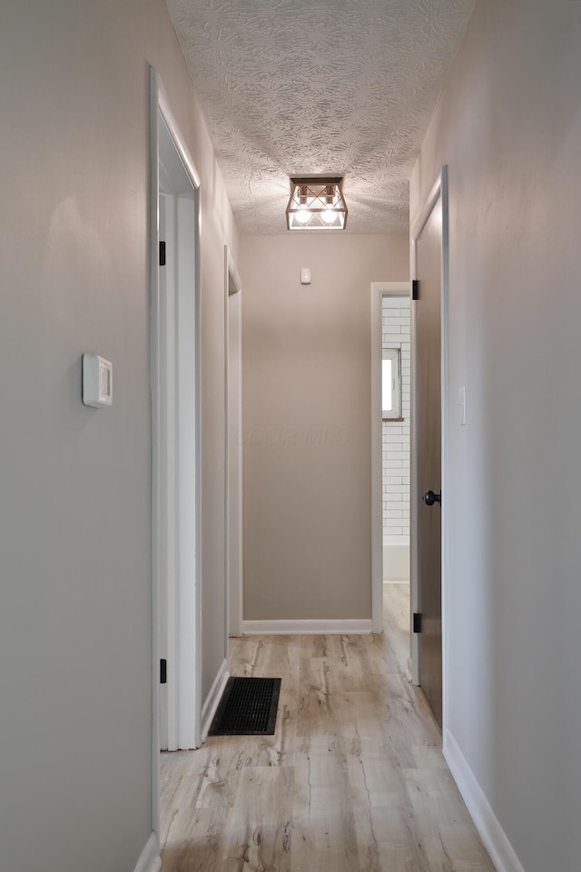 1235 Beechwood Rd, Columbus, OH 43227 - hallway with a textured ceiling and wood finished floors