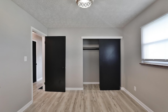 1235 Beechwood Rd, Columbus, OH 43227 - unfurnished bedroom with wood finished floors, a closet, and a textured ceiling
