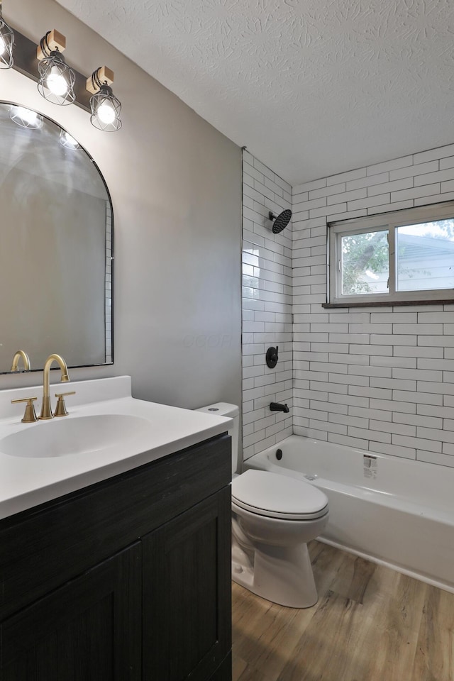 1235 Beechwood Rd, Columbus, OH 43227 - bathroom with wood finished floors, a textured ceiling, vanity, and  shower combination