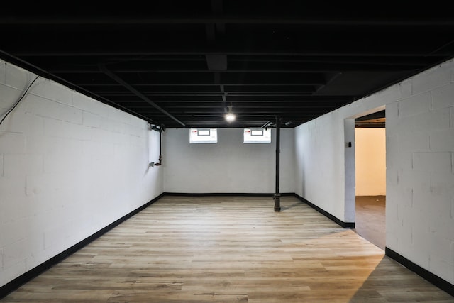 1235 Beechwood Rd, Columbus, OH 43227 - below grade area featuring light wood-type flooring and concrete block wall