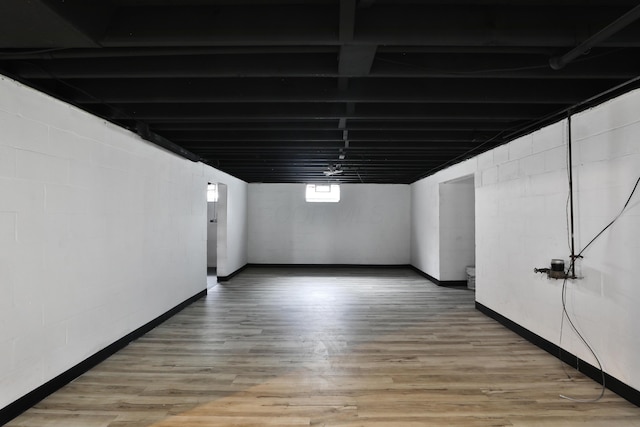1235 Beechwood Rd, Columbus, OH 43227 - below grade area with light wood-style floors and concrete block wall