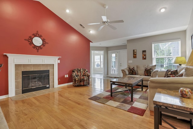 living area featuring visible vents, a ceiling fan, light wood-style flooring, and a wealth of natural light