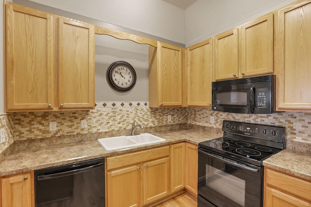 kitchen featuring tasteful backsplash, a sink, light countertops, black appliances, and light brown cabinets