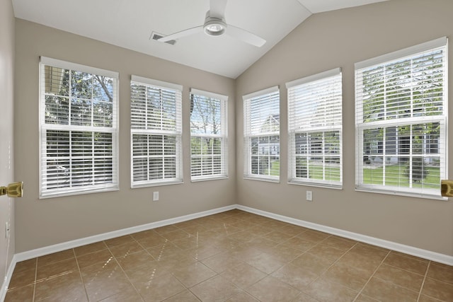 unfurnished sunroom featuring baseboards, visible vents, tile patterned floors, and lofted ceiling