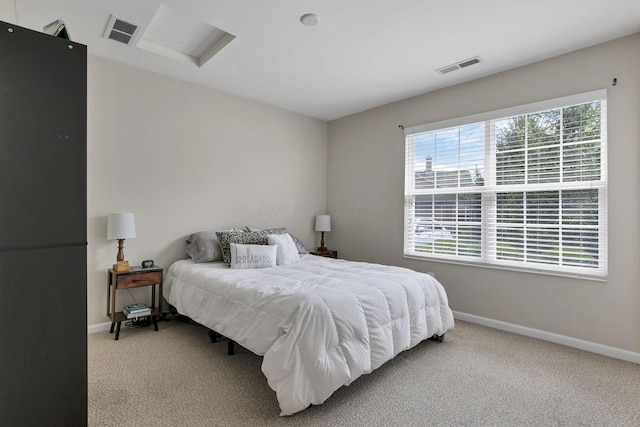carpeted bedroom featuring baseboards and visible vents