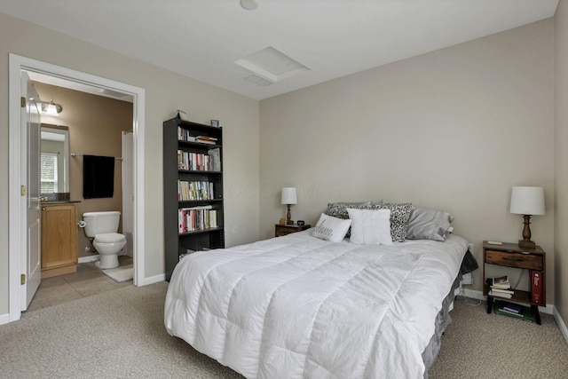 bedroom with light colored carpet, connected bathroom, and baseboards