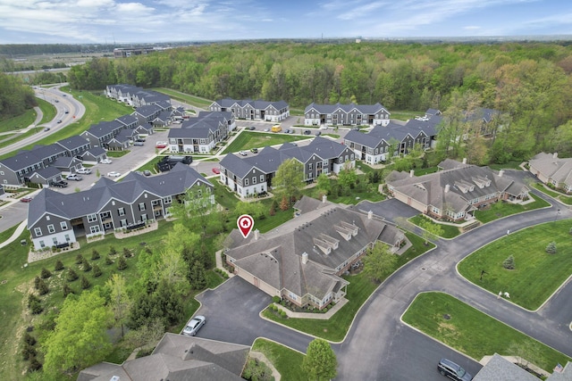 bird's eye view featuring a view of trees and a residential view