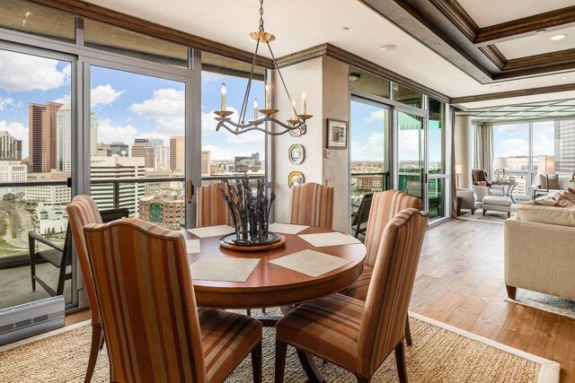 1 Miranova Pl Unit 2230, Columbus, OH 43215 - dining area featuring floor to ceiling windows, an inviting chandelier, crown molding, a view of city, and light wood-style floors