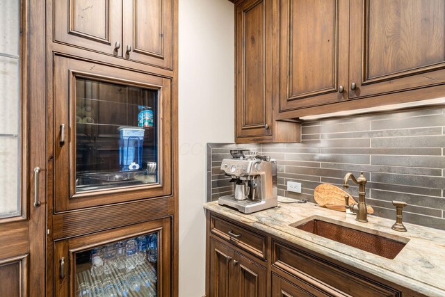 1 Miranova Pl Unit 2230, Columbus, OH 43215 - kitchen featuring a sink, decorative backsplash, and light stone countertops