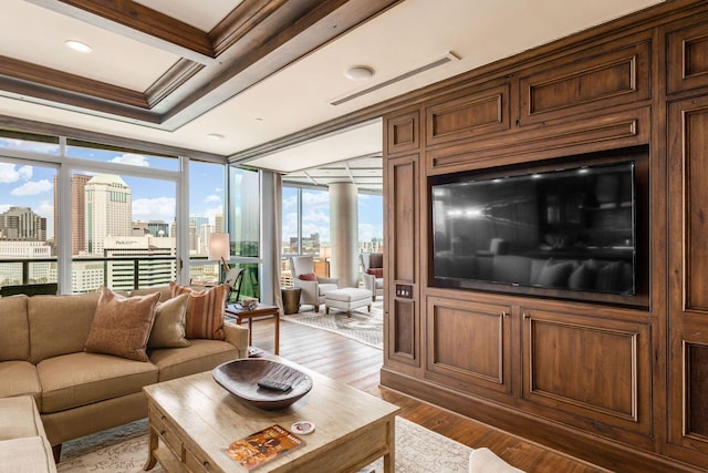 living room with wood finished floors, beamed ceiling, visible vents, ornamental molding, and coffered ceiling