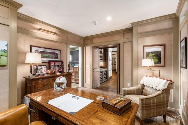 office featuring wood finished floors, crown molding, and a decorative wall