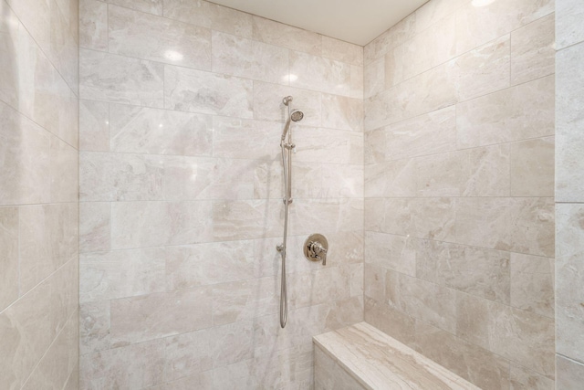 full bath featuring tiled shower