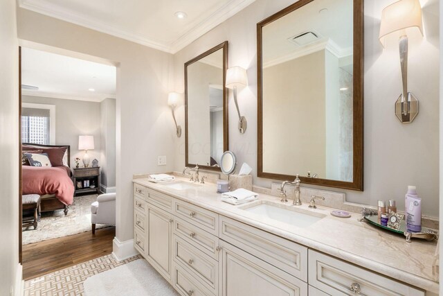 1 Miranova Pl Unit 2230, Columbus, OH 43215 - bathroom with crown molding, double vanity, a sink, and wood finished floors