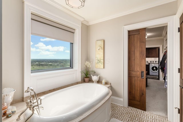 full bathroom featuring baseboards, ornamental molding, washer / dryer, and a bath