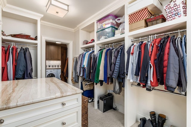 walk in closet featuring carpet and washing machine and dryer