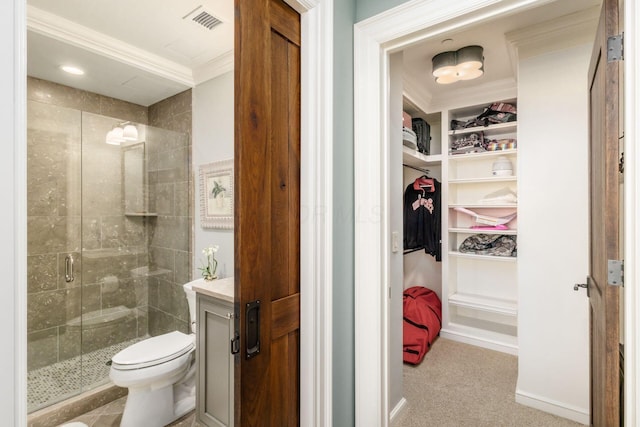 full bathroom with crown molding, visible vents, toilet, a walk in closet, and a stall shower