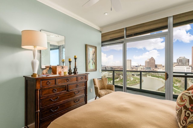 bedroom featuring a ceiling fan, ornamental molding, access to exterior, baseboards, and a city view