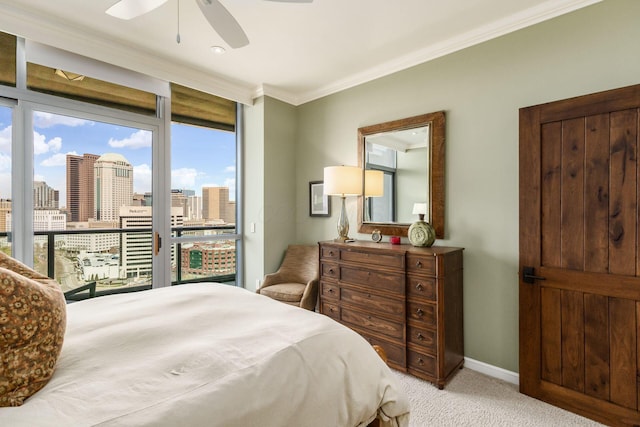 bedroom with ornamental molding, a view of city, light carpet, baseboards, and access to outside