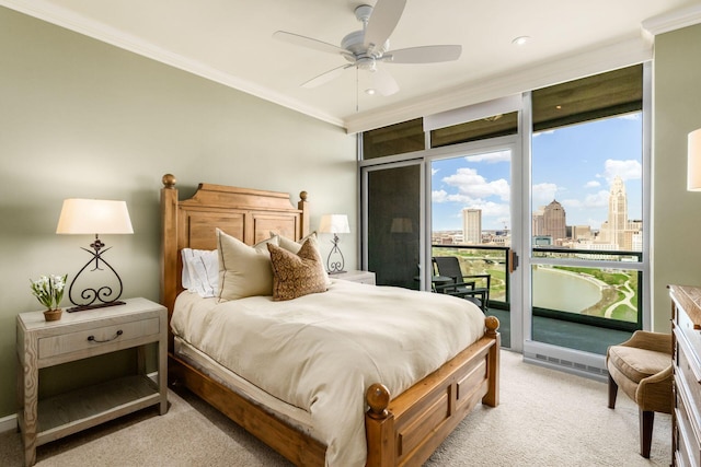 bedroom featuring crown molding, multiple windows, light carpet, access to exterior, and a city view