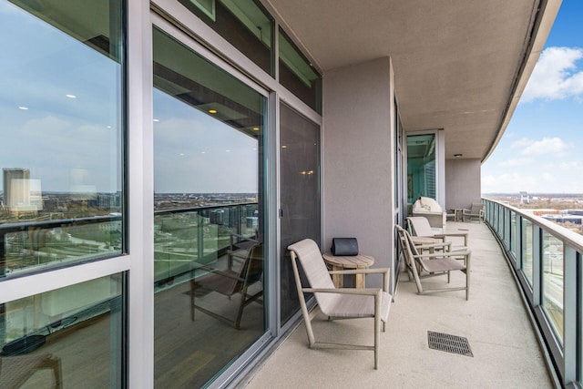 balcony with a view of city and visible vents