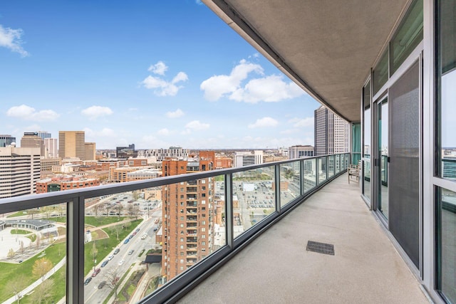 balcony with visible vents and a view of city