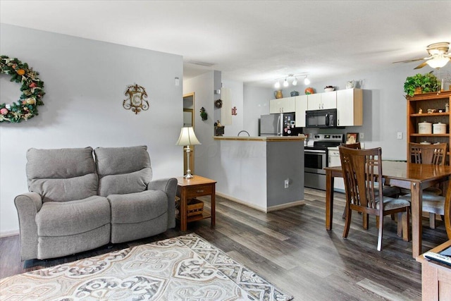 2744 Brittany Oaks Blvd, Hilliard, OH 43026 - living area with dark wood-type flooring, ceiling fan, and baseboards