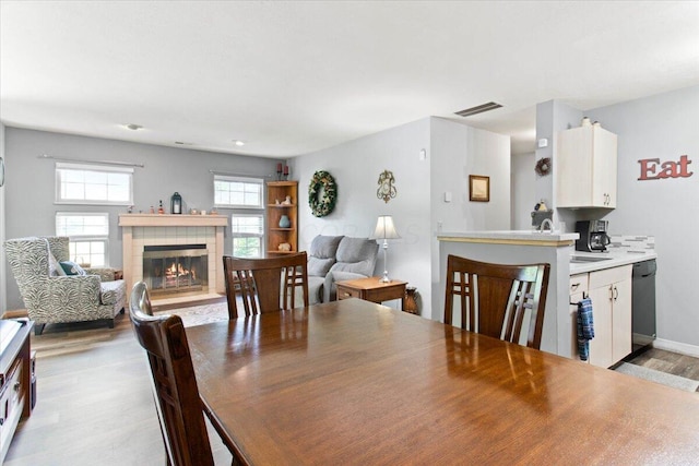 2744 Brittany Oaks Blvd, Hilliard, OH 43026 - dining room with light wood finished floors and a tile fireplace