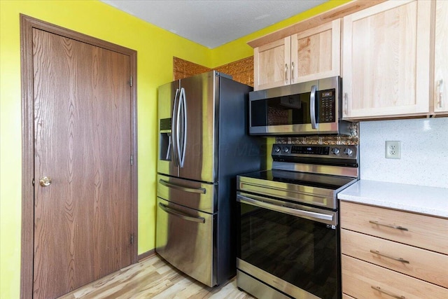 186 Lexington Blvd, Delaware, OH 43015 - kitchen featuring stainless steel appliances, light wood-type flooring, light countertops, and light brown cabinets