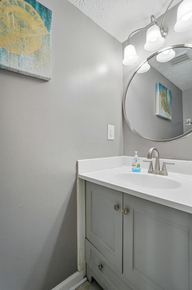 7622 Elgin Trail Dr, Blacklick, OH 43004 - bathroom with vanity, a textured ceiling, and baseboards