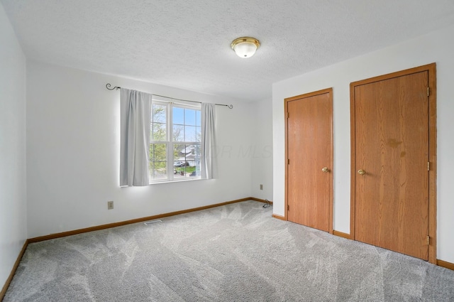 7622 Elgin Trail Dr, Blacklick, OH 43004 - unfurnished bedroom with carpet, two closets, visible vents, and baseboards