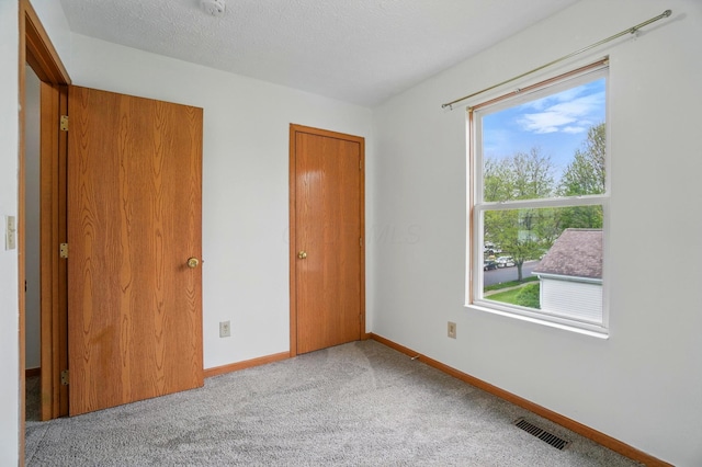 7622 Elgin Trail Dr, Blacklick, OH 43004 - unfurnished bedroom with baseboards, light carpet, and visible vents
