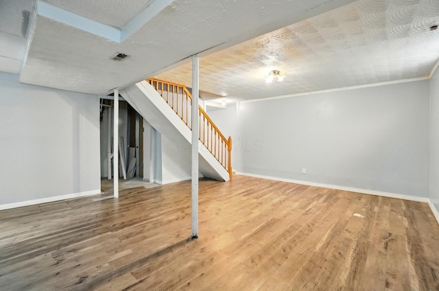7622 Elgin Trail Dr, Blacklick, OH 43004 - finished basement featuring wood finished floors, stairway, baseboards, and visible vents
