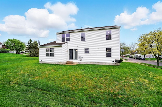 7622 Elgin Trail Dr, Blacklick, OH 43004 - back of property featuring central AC unit, entry steps, and a lawn