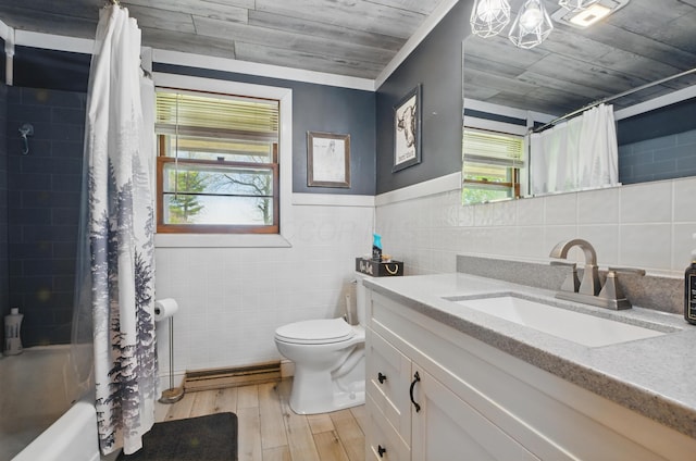 full bathroom with tile walls, wood finished floors, vanity, a baseboard radiator, and toilet