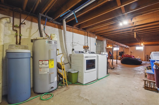 unfinished basement with washing machine and clothes dryer and electric water heater