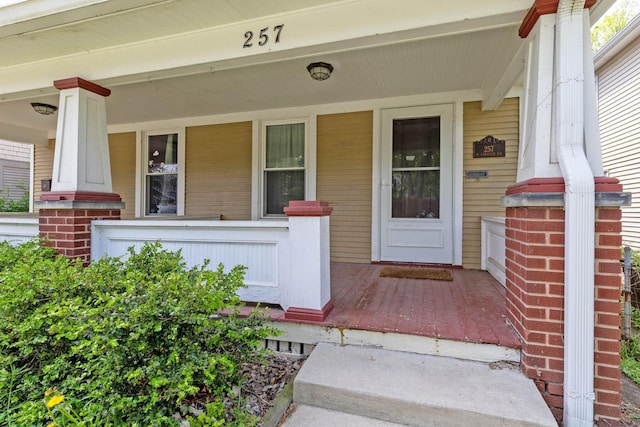 view of exterior entry with covered porch
