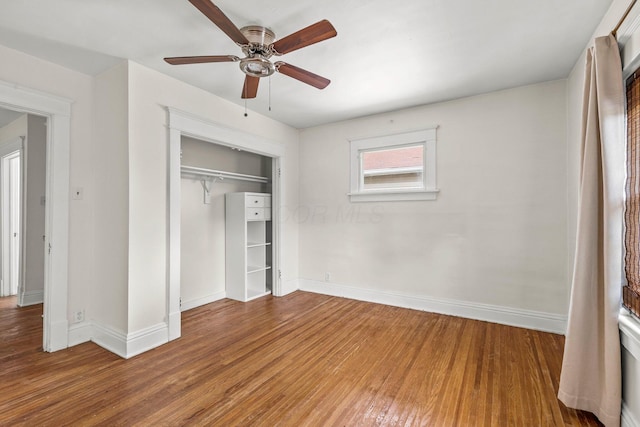 unfurnished bedroom with baseboards, a ceiling fan, a closet, and wood finished floors