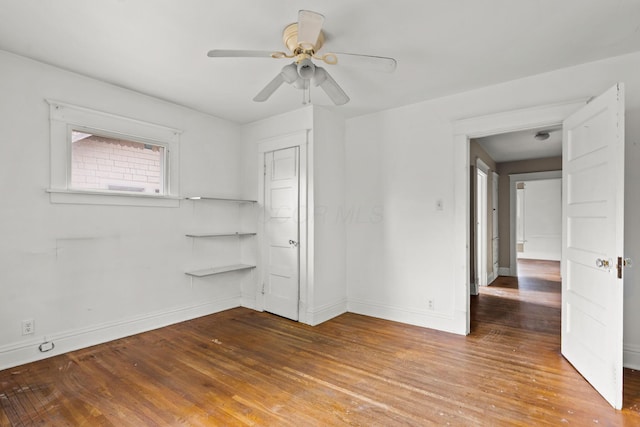unfurnished bedroom with baseboards, ceiling fan, and hardwood / wood-style flooring