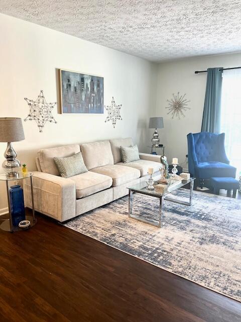 4708 Parrau Dr Unit 60D, Columbus, OH 43228 - living area featuring a textured ceiling and wood finished floors