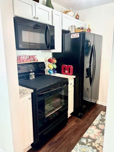 4708 Parrau Dr Unit 60D, Columbus, OH 43228 - kitchen with white cabinets, dark wood-style flooring, and black appliances