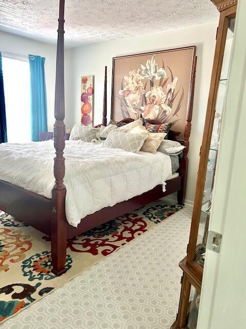 4708 Parrau Dr Unit 60D, Columbus, OH 43228 - bedroom with tile patterned floors and a textured ceiling