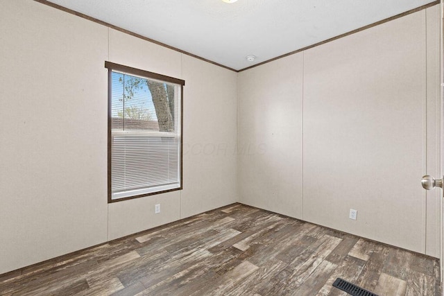 4711 Walnut Rd Lot K-5, Buckeye Lake, OH 43008 - spare room featuring crown molding, visible vents, and wood finished floors