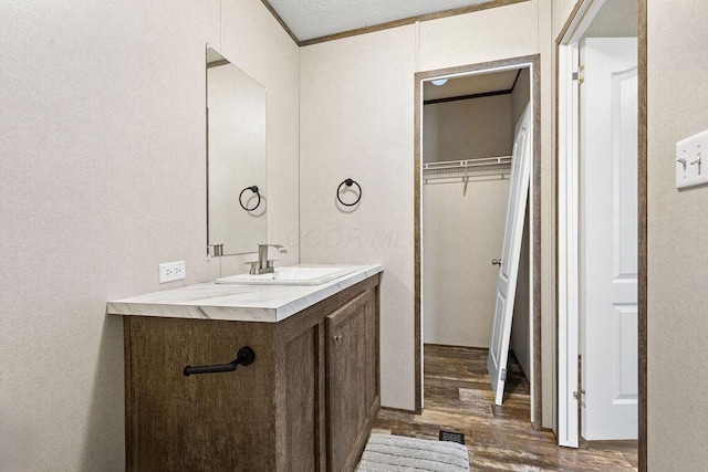 4711 Walnut Rd Lot K-5, Buckeye Lake, OH 43008 - bathroom with a walk in closet, visible vents, wood finished floors, and vanity
