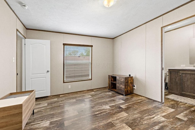 4711 Walnut Rd Lot K-5, Buckeye Lake, OH 43008 - unfurnished bedroom featuring ornamental molding, a textured ceiling, and wood finished floors