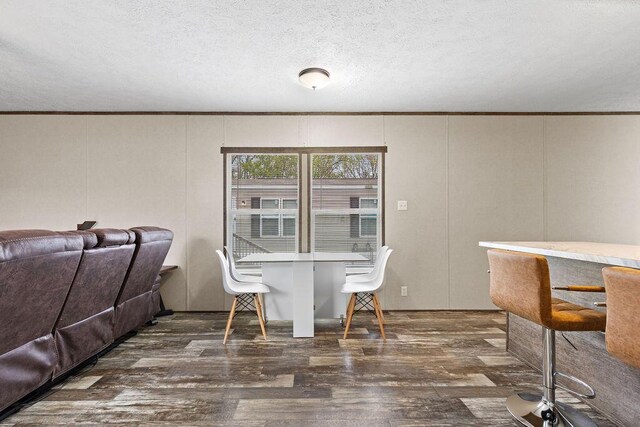 4711 Walnut Rd Lot K-5, Buckeye Lake, OH 43008 - dining space with wood finished floors, ornamental molding, a textured ceiling, and a decorative wall