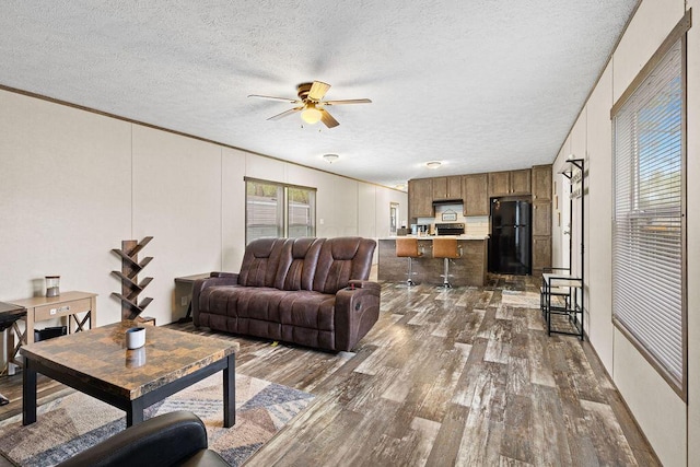 4711 Walnut Rd Lot K-5, Buckeye Lake, OH 43008 - living area with crown molding, a ceiling fan, dark wood-style flooring, and a textured ceiling